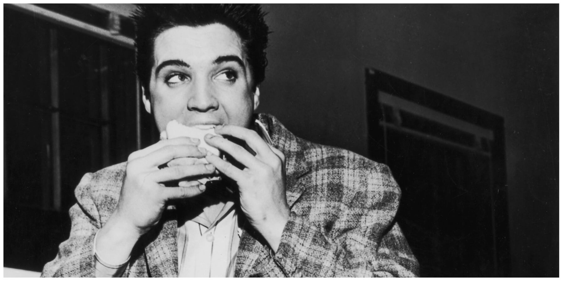 Elvis Presley eats a sandwich in Memphis, TN in 1958.