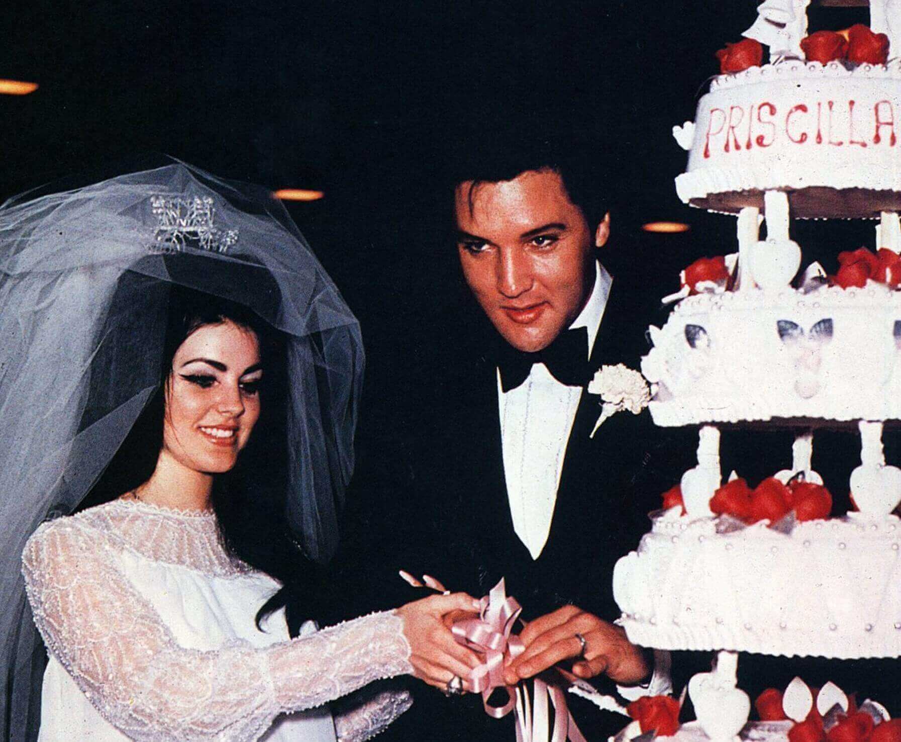 Priscilla Presley and Elvis Presley with a cake