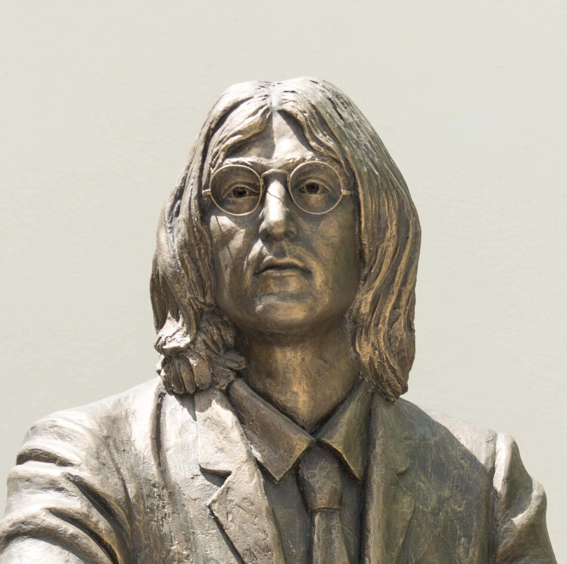 A statue of "Imagine" singer John Lennon wearing glasses