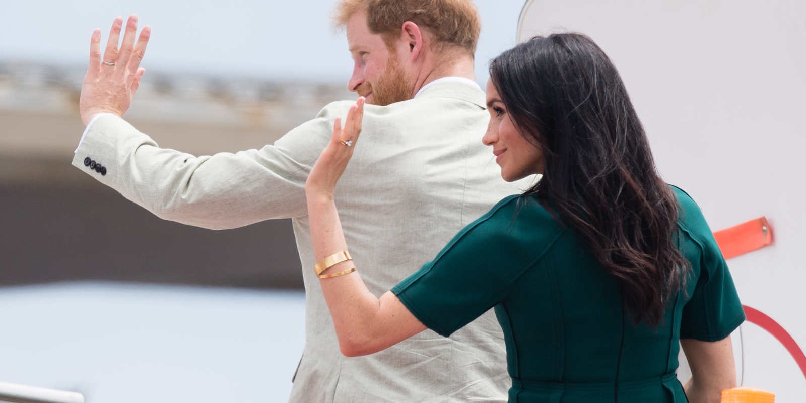 Prince Harry and Meghan Markle wave as they depart from Nadi airport on October 25, 2018 in Nadi, Fiji.