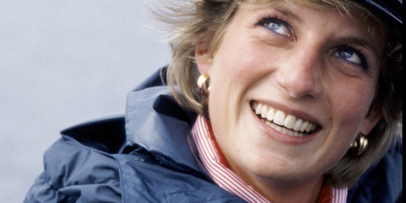 Princess Diana poses for a photo wearing a naval hat.