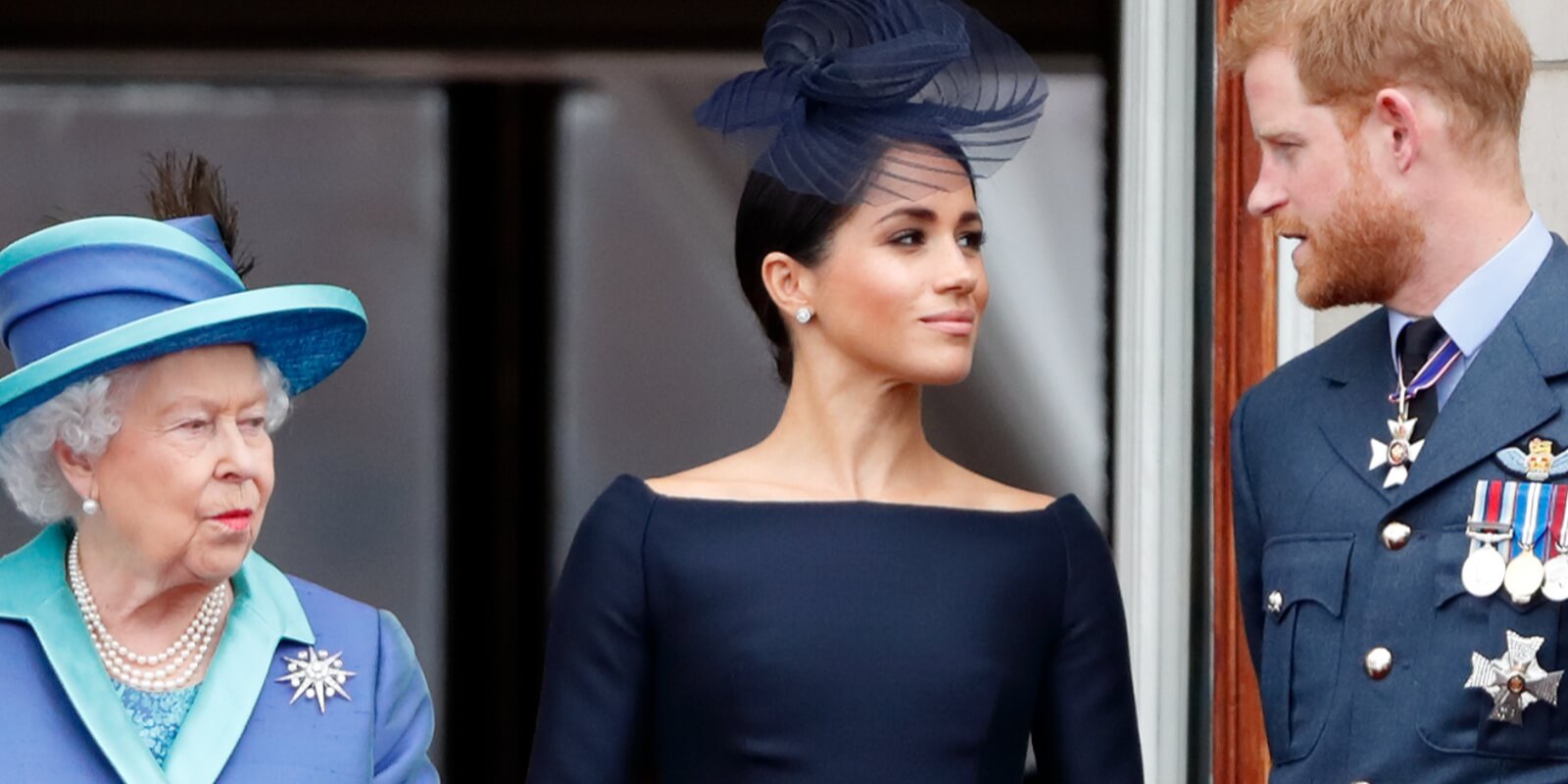 Queen Elizabeth, Meghan Markle and Prince Harry watch a flypast to mark the centenary of the Royal Air Force from the balcony of Buckingham Palace on July 10, 2018 in London, England.