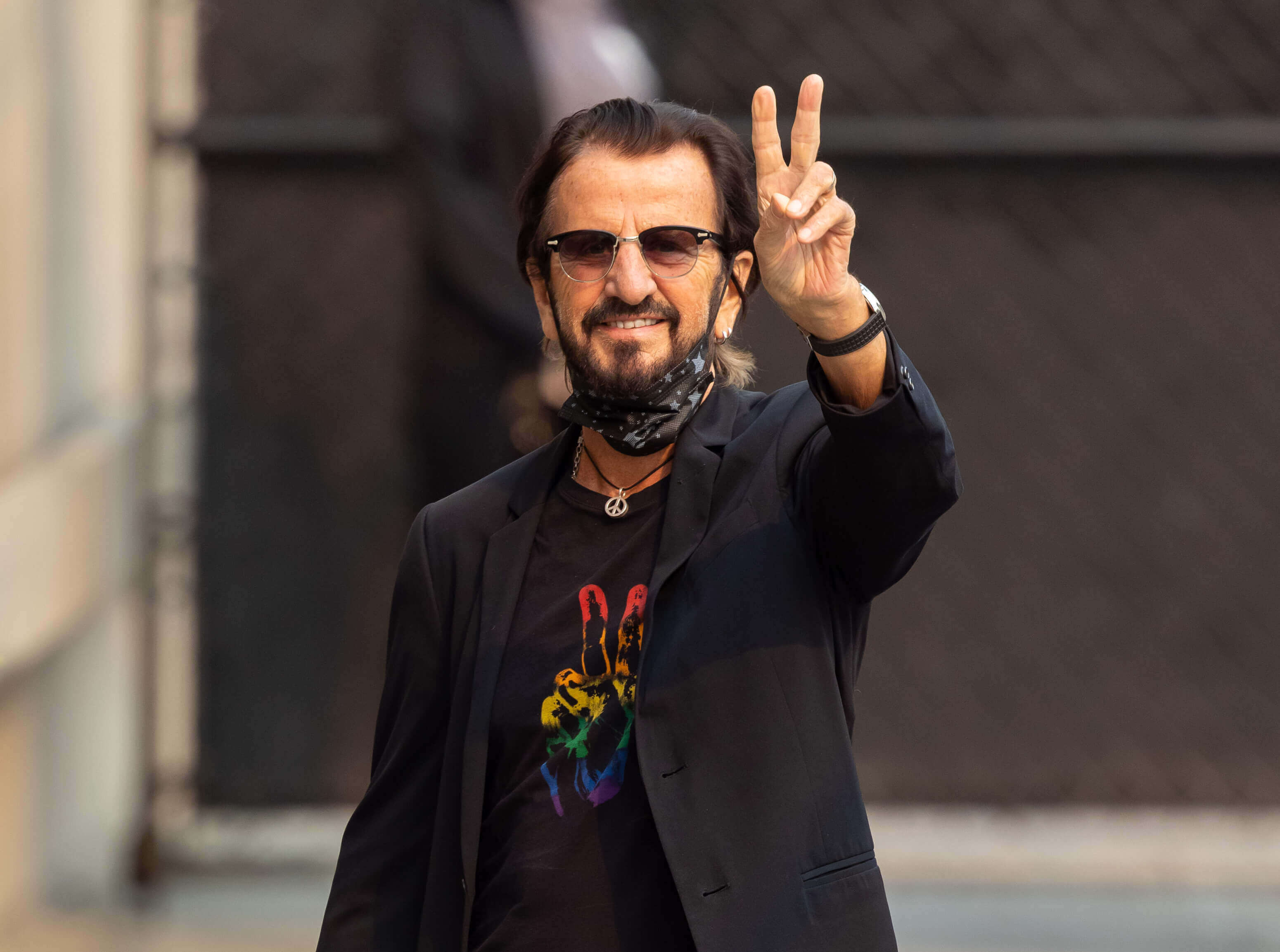 The Beatles' Ringo Starr wearing a shirt with an image of a hand on it