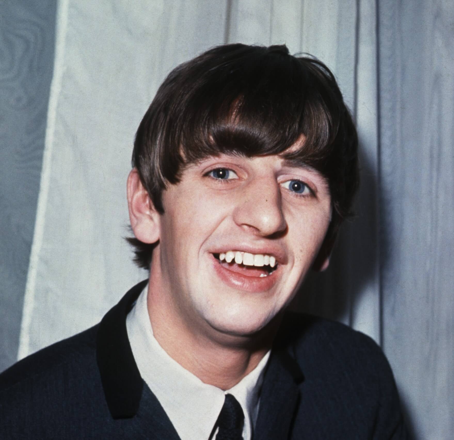 The Beatles' Ringo Starr in front of a curtain