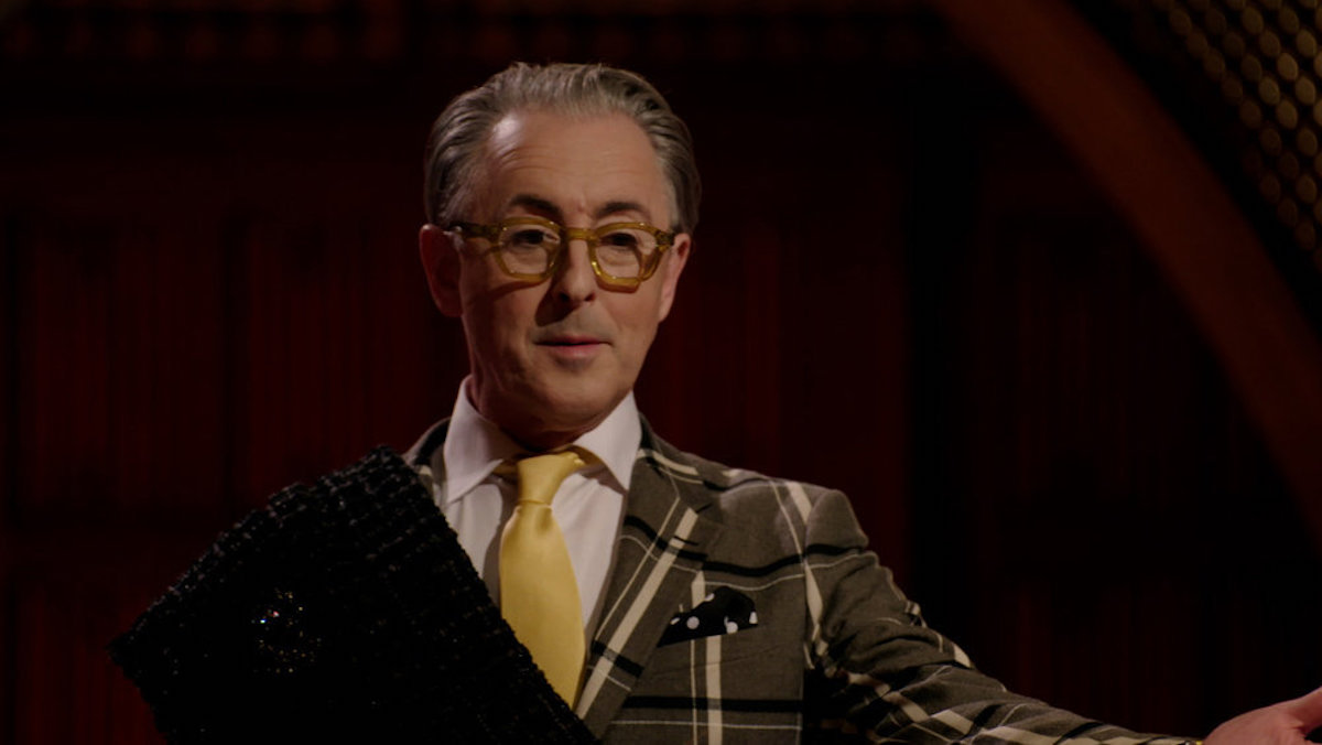 Alan Cumming in glasses and a yellow tie in 'The Traitors'