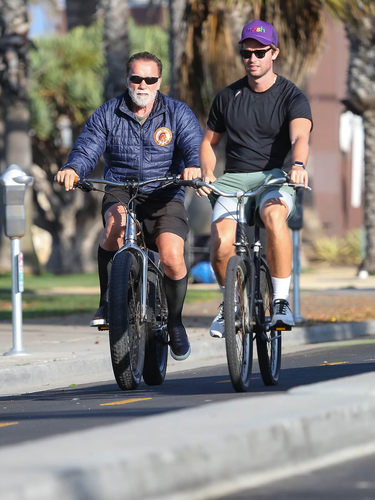 Arnold Schwarzenegger and his son Patrick Schwarzenegger are seen riding bikes in LA