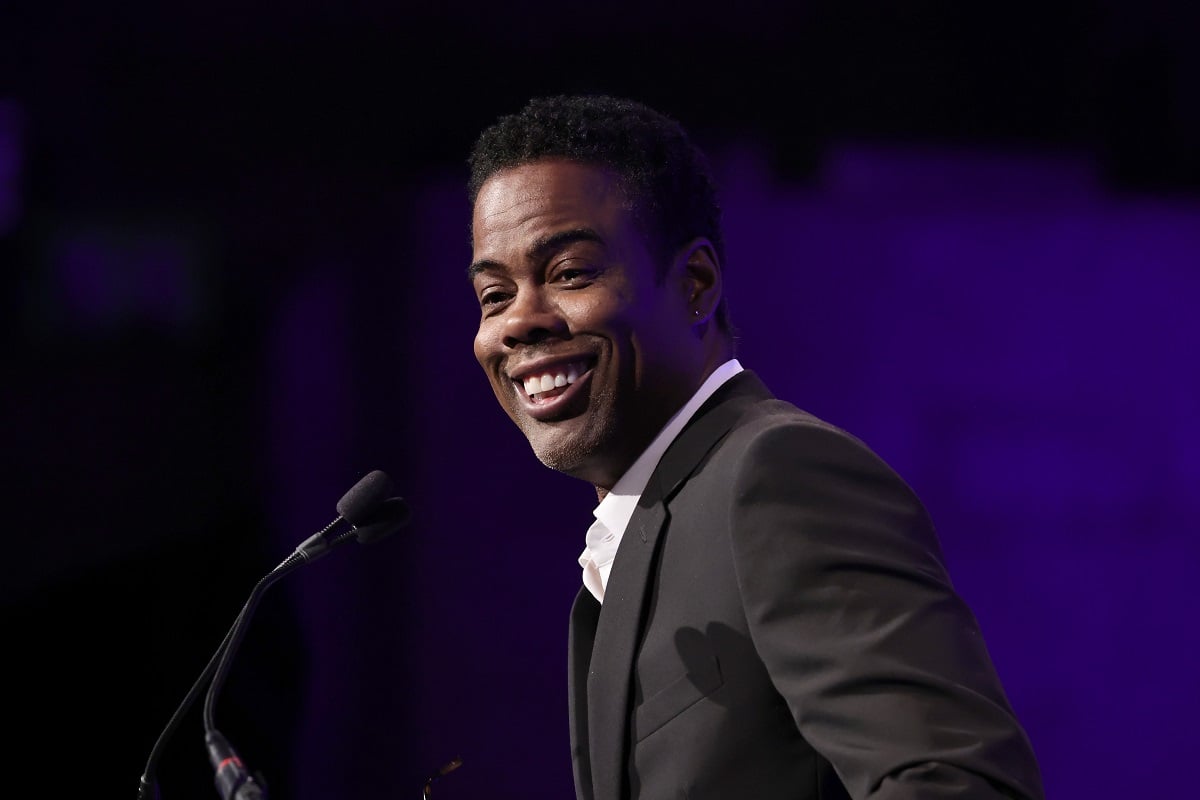 Chris Rock smiling in a suit at the National Board of Review annual awards