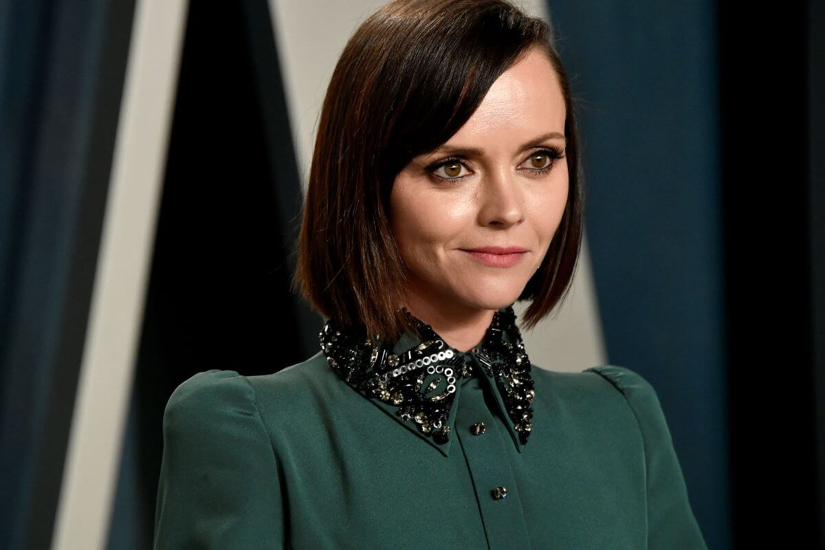 Christina Ricci wears a green shirt with a sequined black collar.