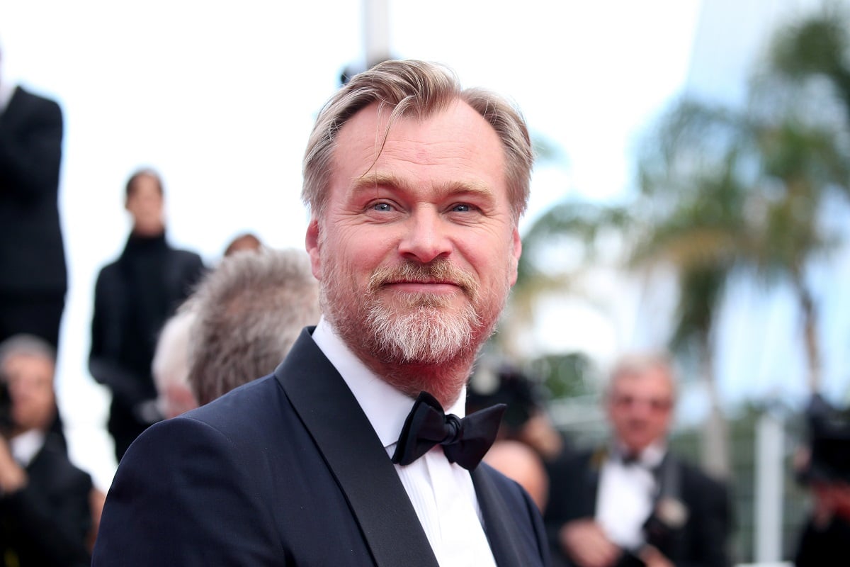 Christopher Nolan posing in a suit at the screening of "2001: A Space Odyssey"