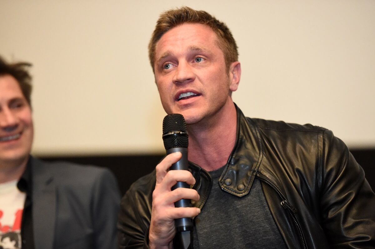 Devon Sawa answering questions with a microphone at the audience questions at the Punk's Dead: SLC Punk 2 premiere event.