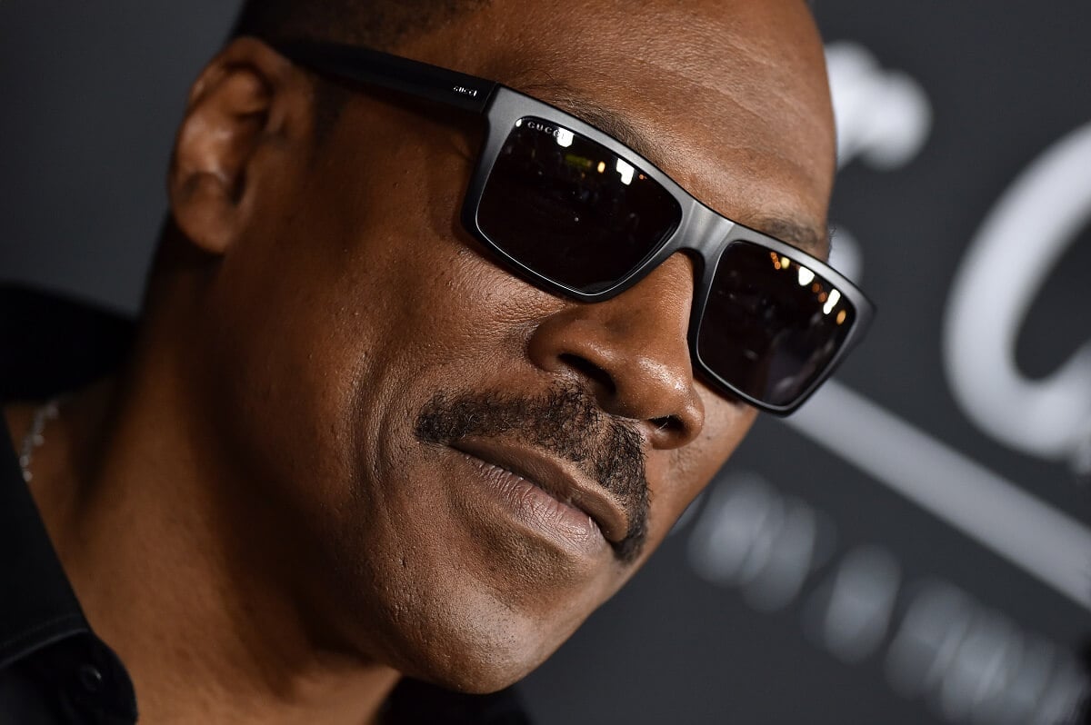 Eddie Murphy posing at the premiere of 'Mr. Church' while wearing sunglasses.