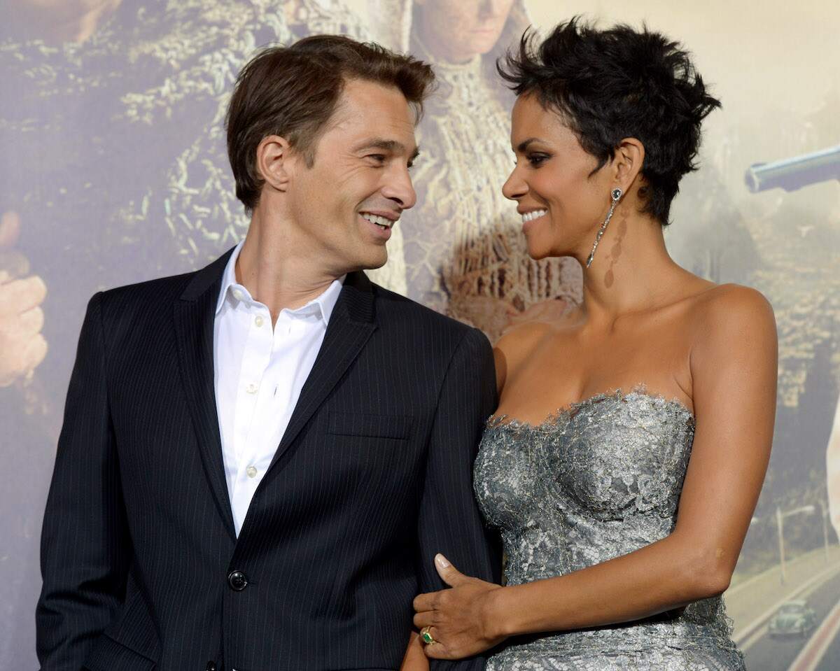 Actors Halle Berry and actor Olivier Martinez smile at each other during the red carpet premiere of Cloud Atlas