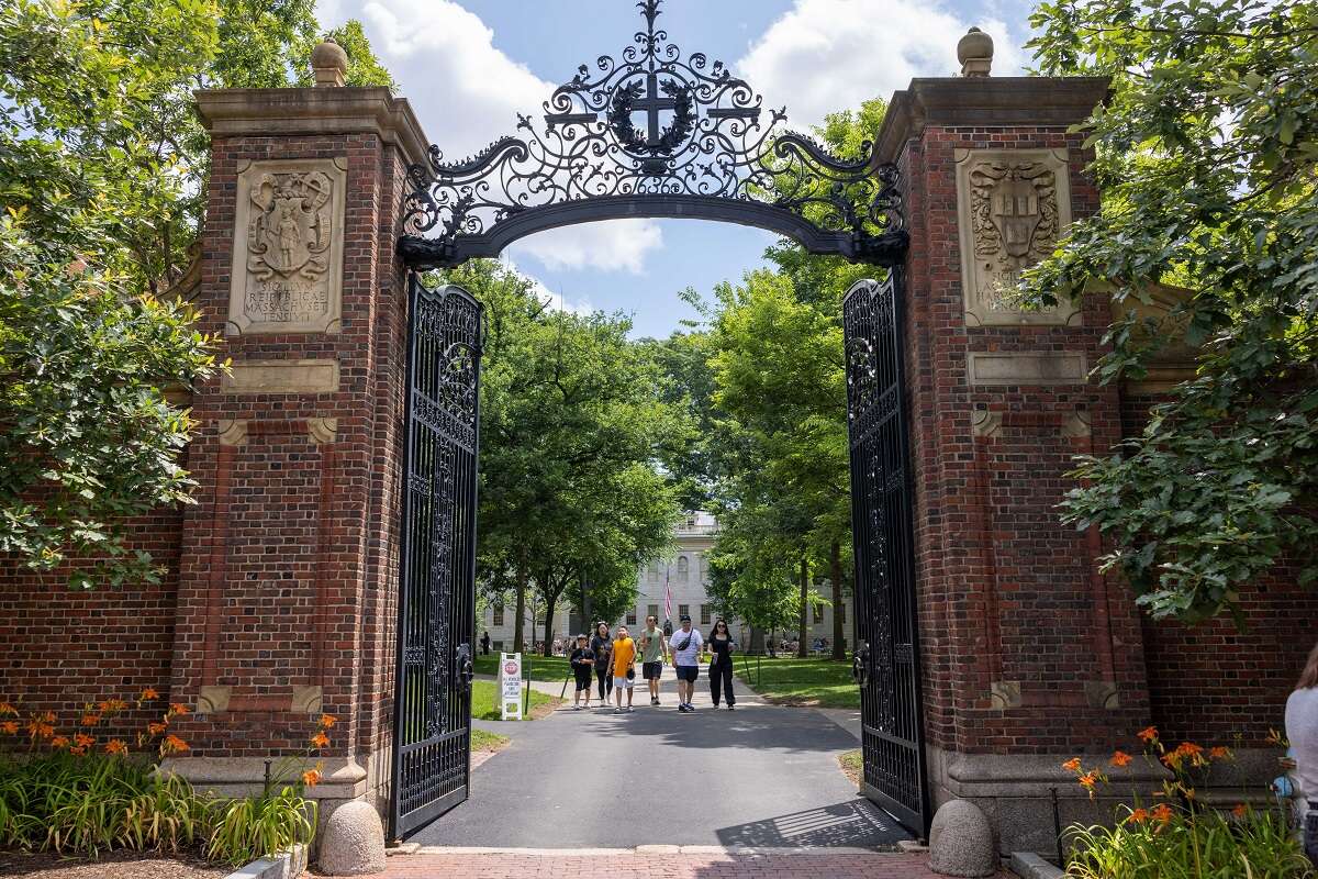 Students walk through the gate at Harvard University in 2023