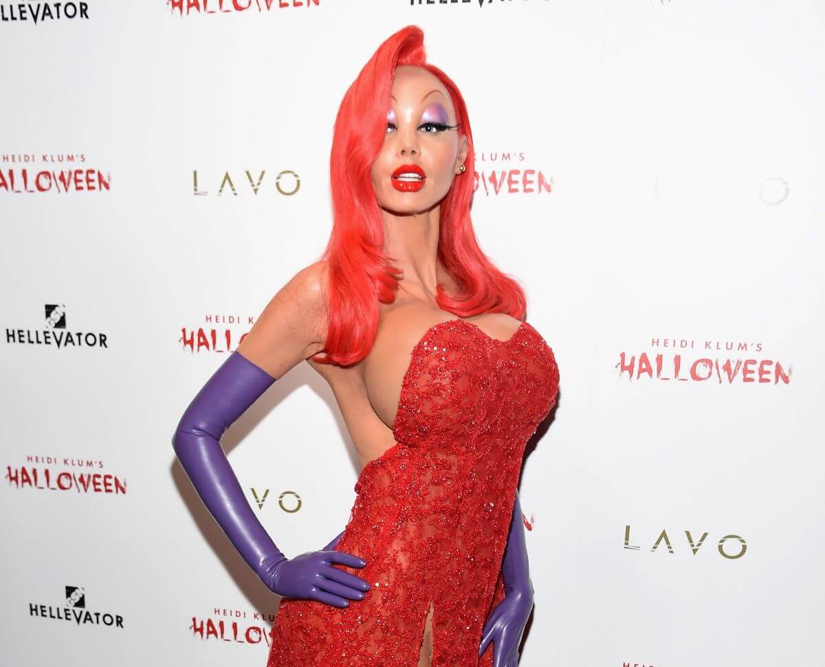 Heidi Klum wears a Jessica Rabbit costume and stands with her hand on her hip.