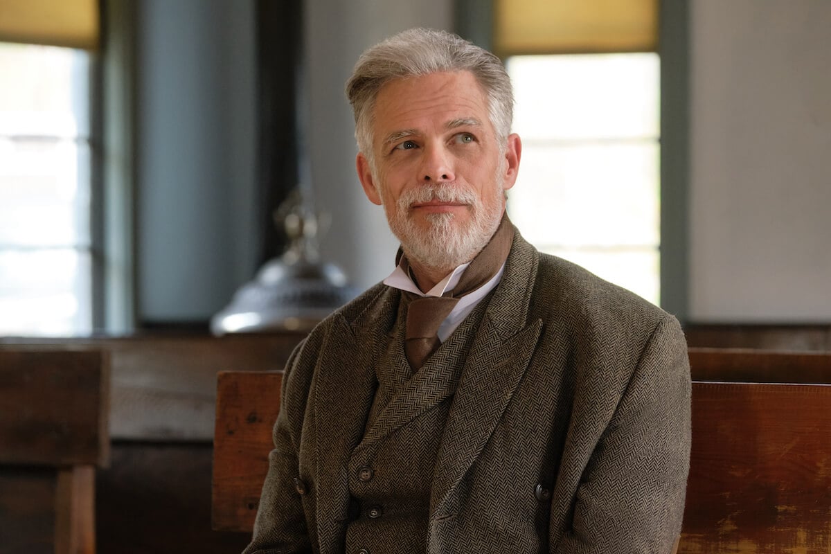 Henry Gowen wearing a suit and smiling in 'When Calls the Heart' Season 10 Episode 8