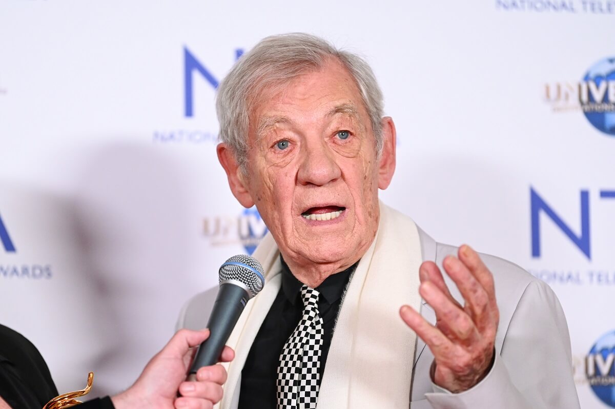 Sir Ian McKellen in the press room at the National Television Awards while speaking into a microphone.