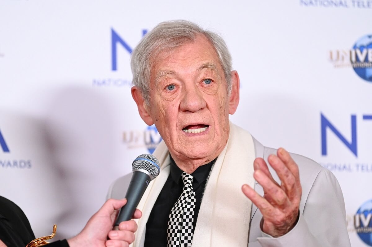 Sir Ian McKellen in the press room at the National Television Awards while speaking into a microphone.