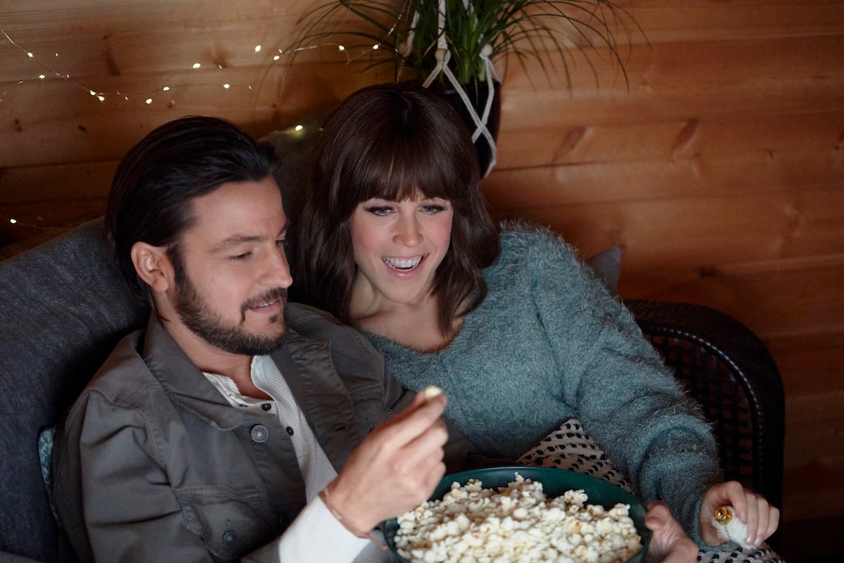 Tyler Hynes and 'When Calls the Heart' cast member eating popcorn in the Hallmark movie 'It Was Always You'