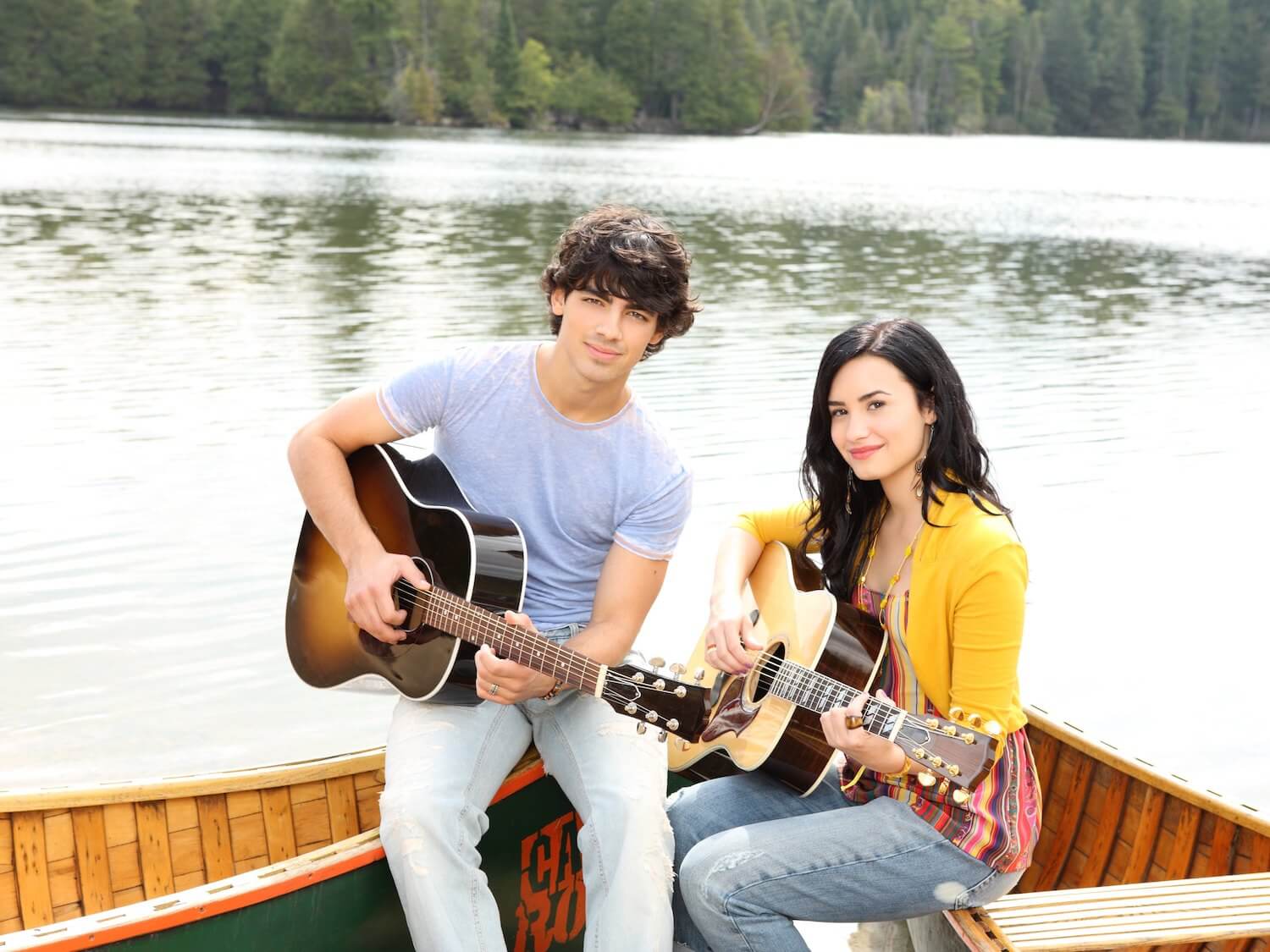 Joe Jonas and Demi Lovato on the set of 'Camp Rock 2.' They're in a canoe playing guitars