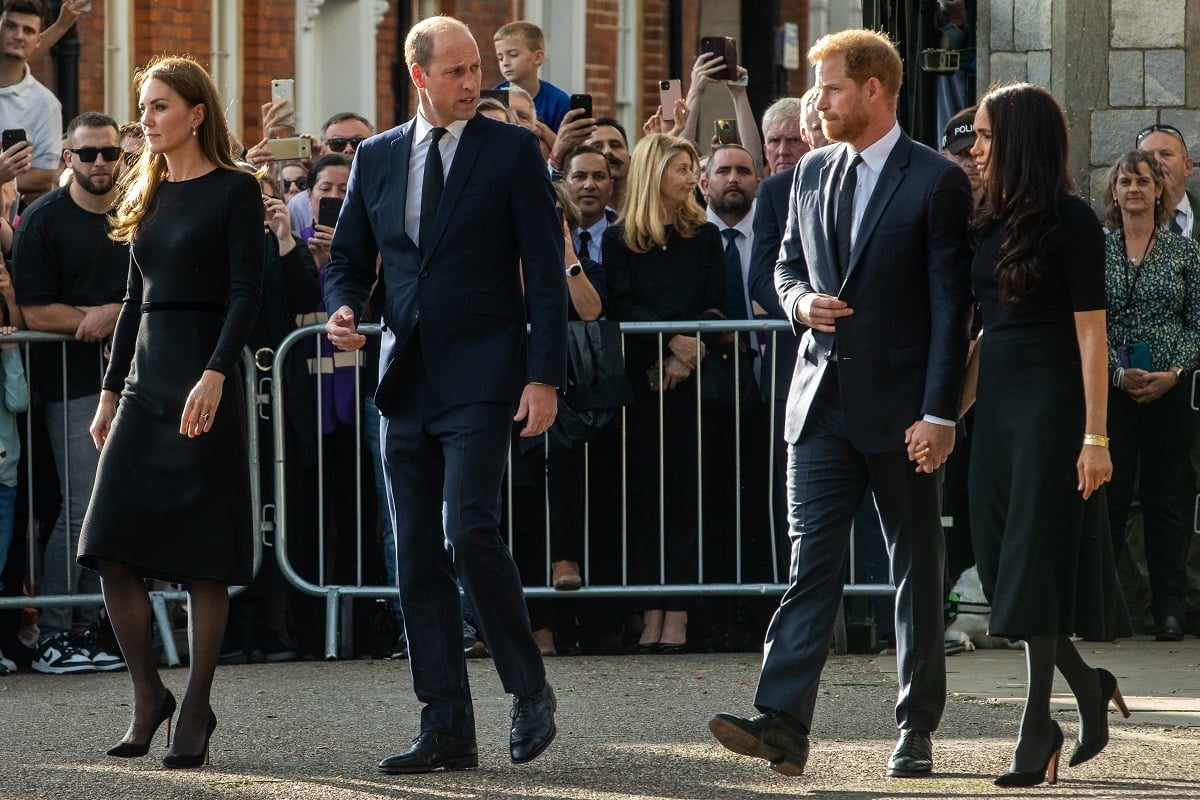 Kate Middleton, Prince William, Prince Harry, and Meghan Markle proceed to greet well-wishers outside Windsor Castle