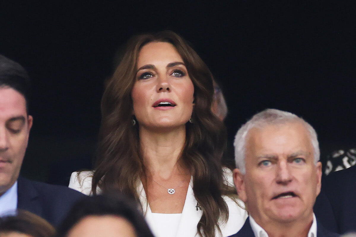 Kate Middleton, who channeled Queen Elizabeth II at the Rugby World Cup, looks on wearing white