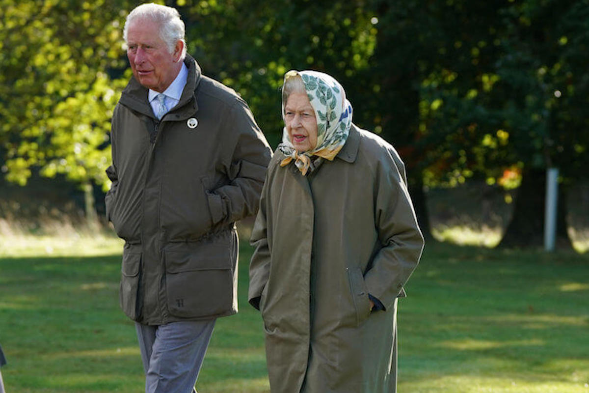 King Charles III and Queen Elizabeth II, who ran down a corridor breaking protocol, walk