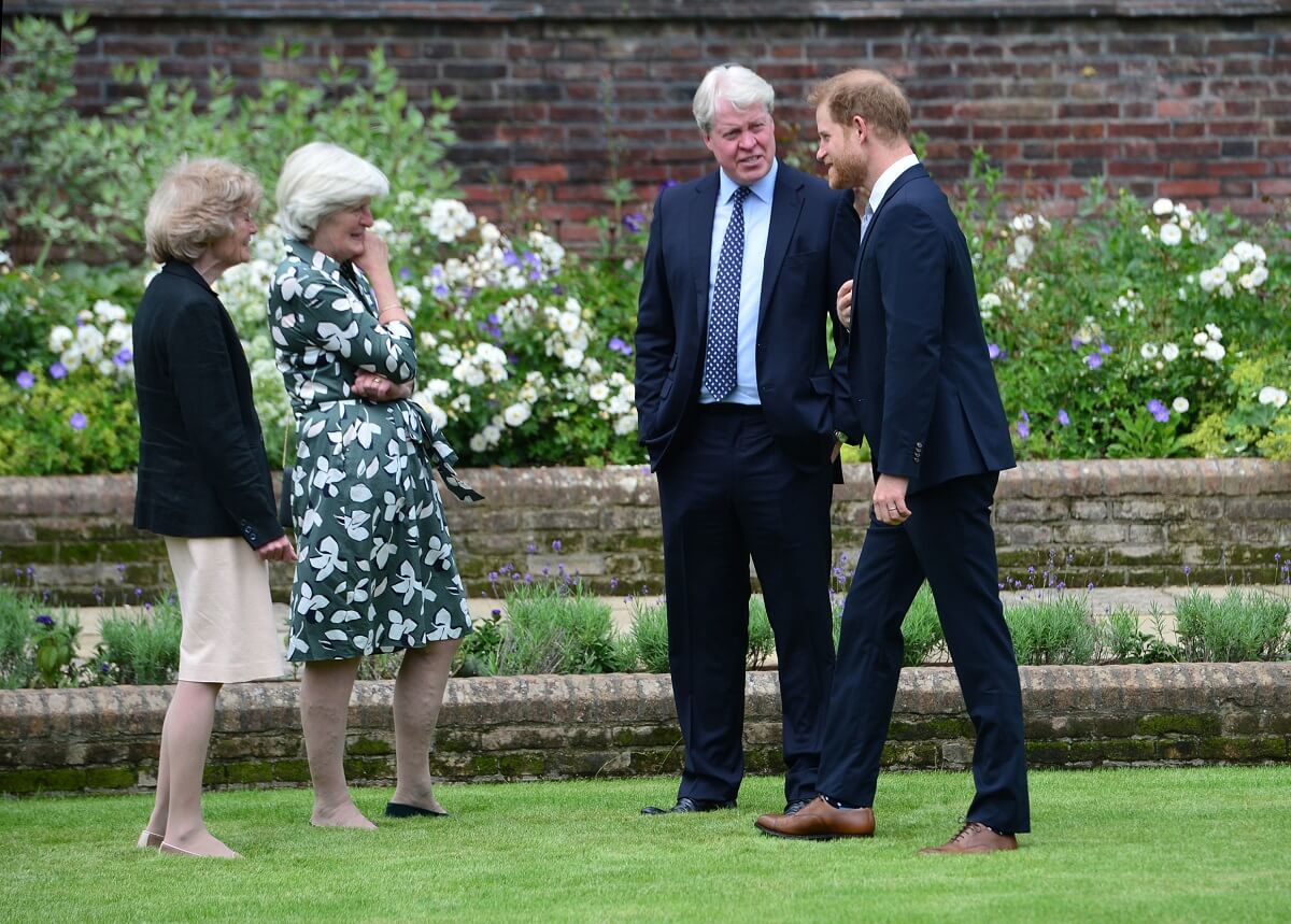 Lady Sarah McCorquodale, Lady Jane Fellowes, and Charles Earl Spencer with their nephew Prince Harry during the unveiling of Princess Diana's statue