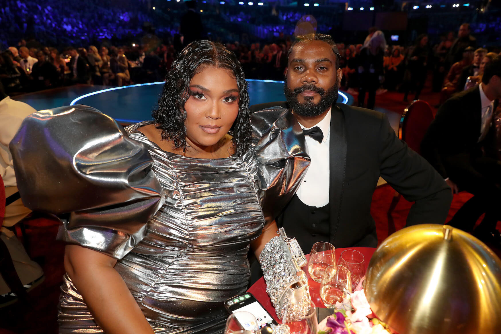 Lizzo and her boyfriend, Myke Wright sitting at a table at the BRIT Awards in February 2023