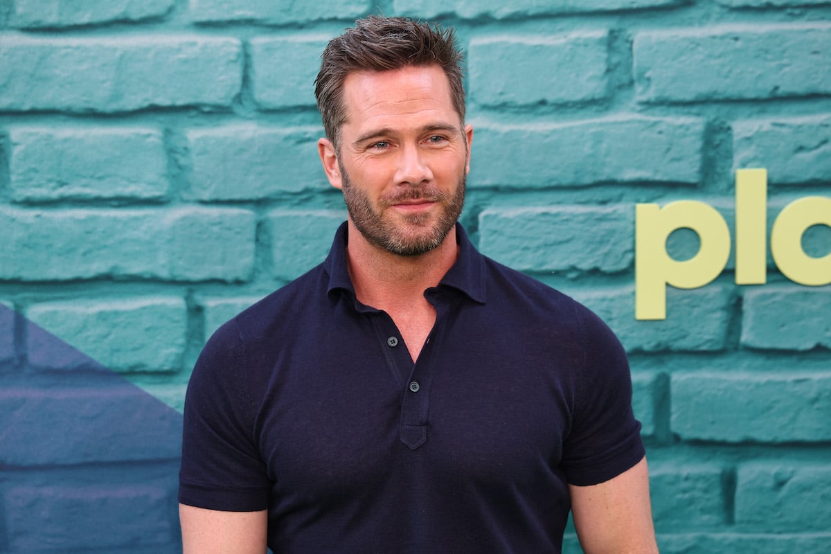 Luke Macfarlane wearing a blue polo shirt