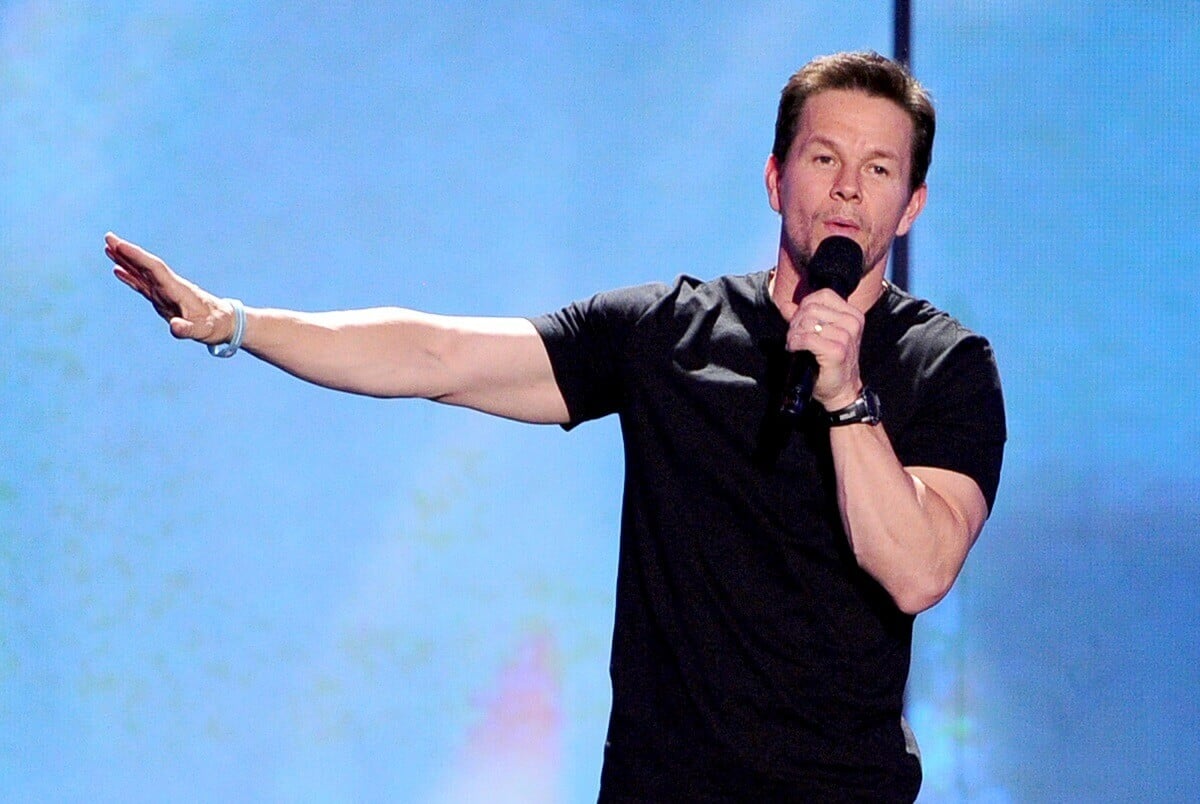 Mark Wahlberg speaking on stage in a black t-shirt at the Nickelodeon Kids' Choice Awards.