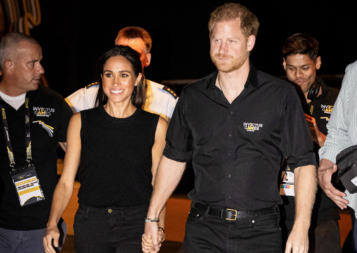 Meghan Markle and Prince Harry hold hands at the Invictus Games.