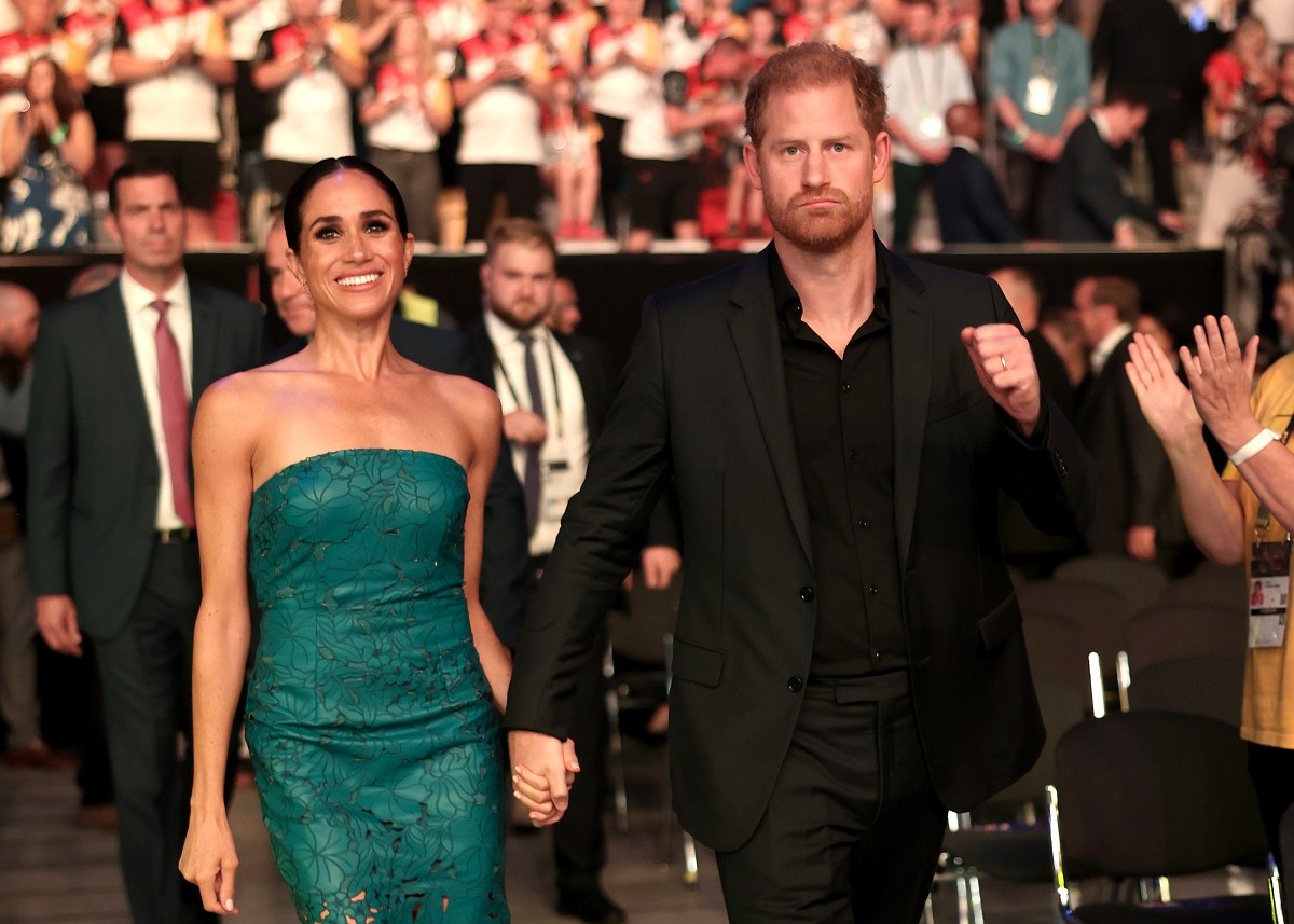 Meghan Markle and Prince Harry, who a former royal aide says are trying to be the 'Prince and Princess of LA,' attend the closing ceremony of the Invictus Games Düsseldorf 2023