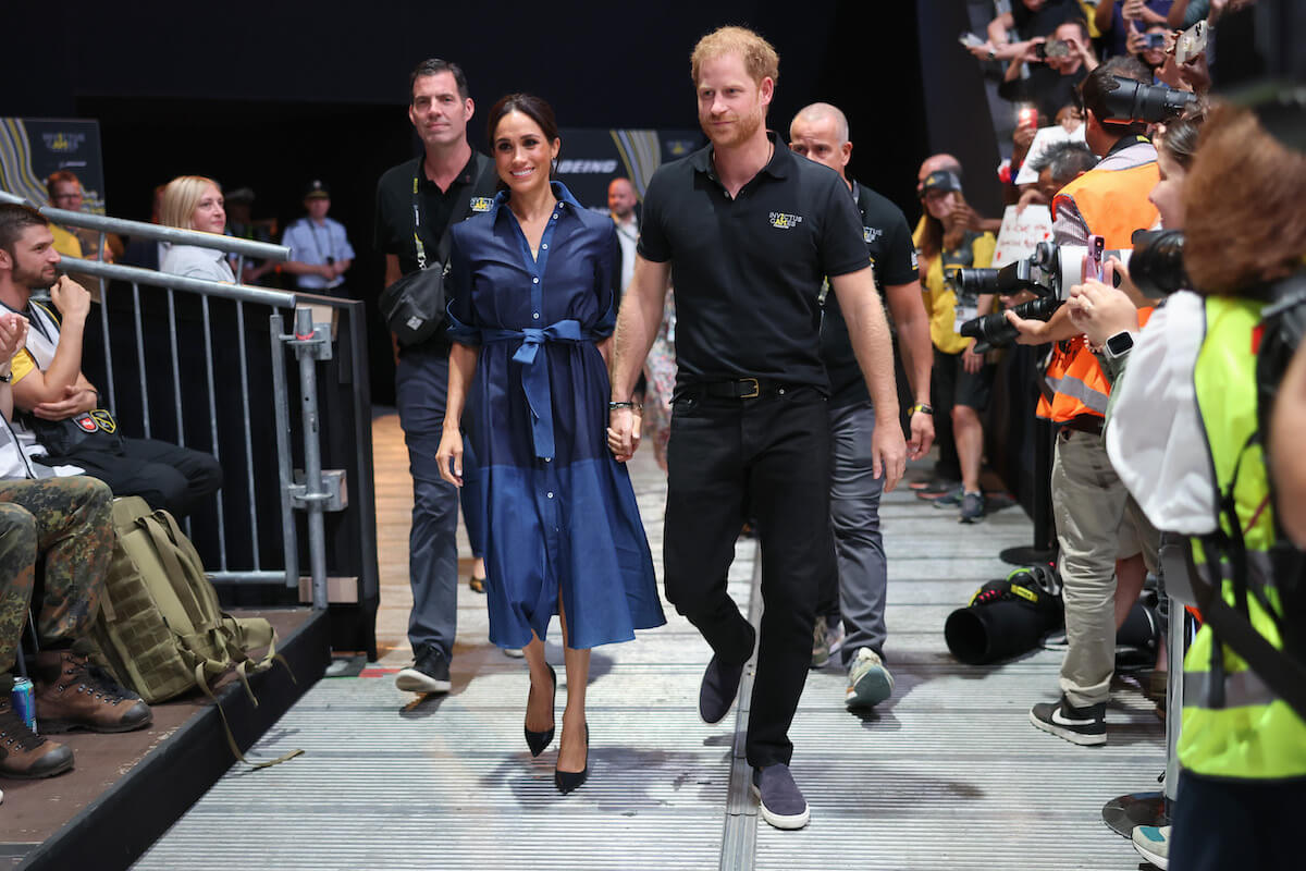 Meghan Markle and Prince Harry, who if were accompanied by Prince Archie and Princess Lilibet, would allow their kids a look at royal life, hold hands at the 2023 Invictus Games