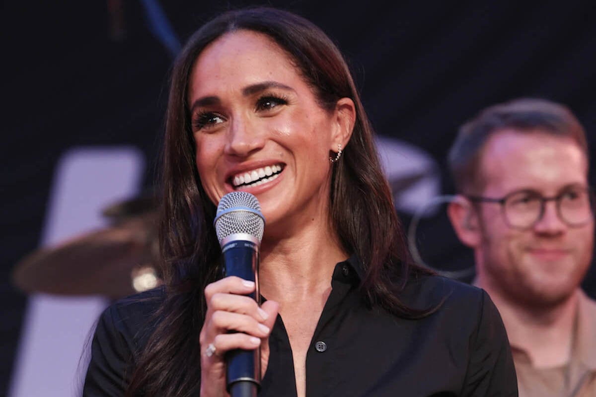Meghan Markle, who grabbed the mic at a Santa Barbara charity event, holds a mic