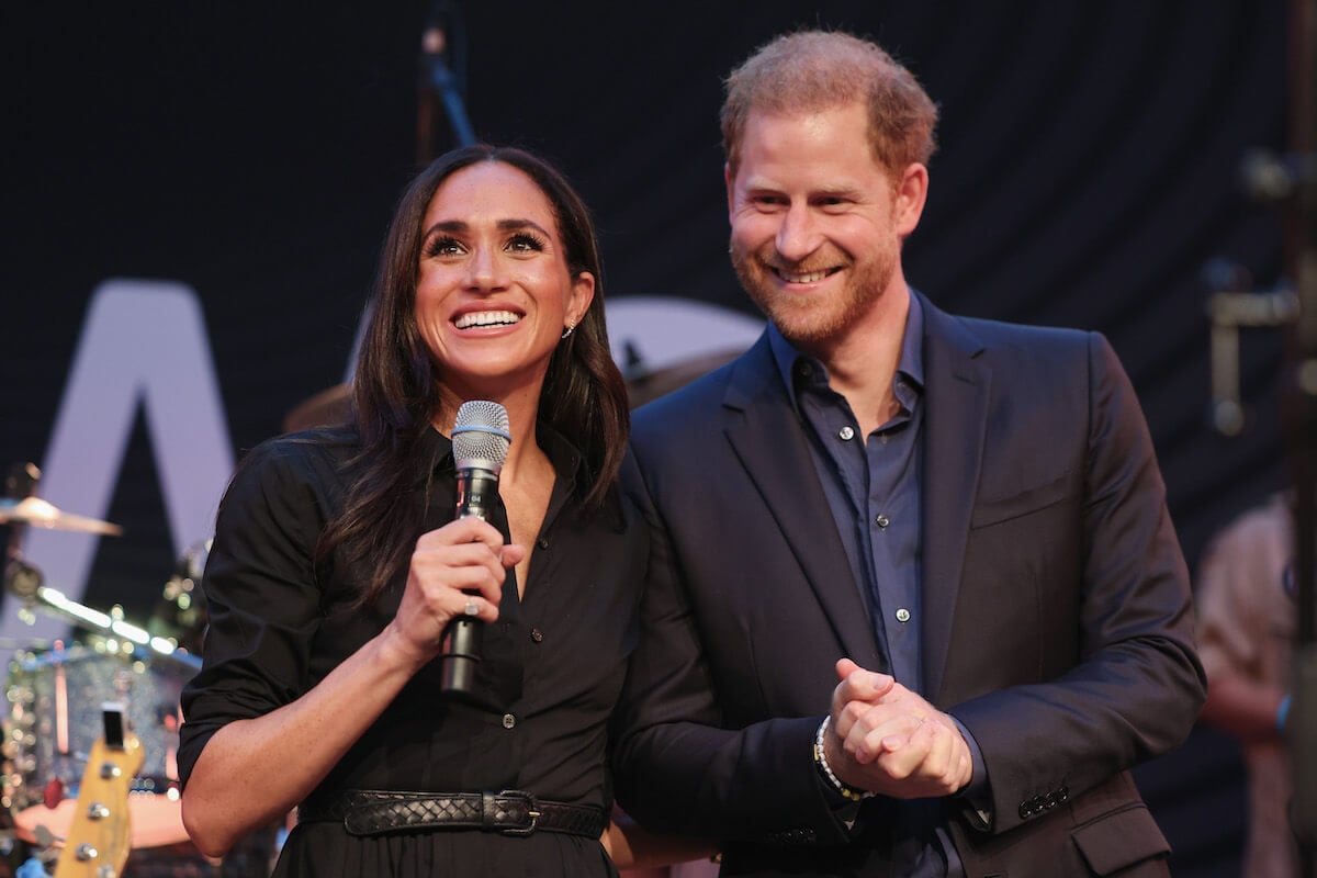 Meghan Markle, who mentioned Archie and Lili, stands with Prince Harry at an Invictus Games event