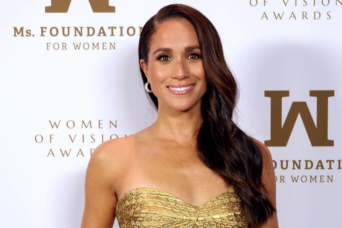 Meghan Markle, who posed for a photo with Kelly Rowland and Kerry Washington at a Beyonce concert, smiles