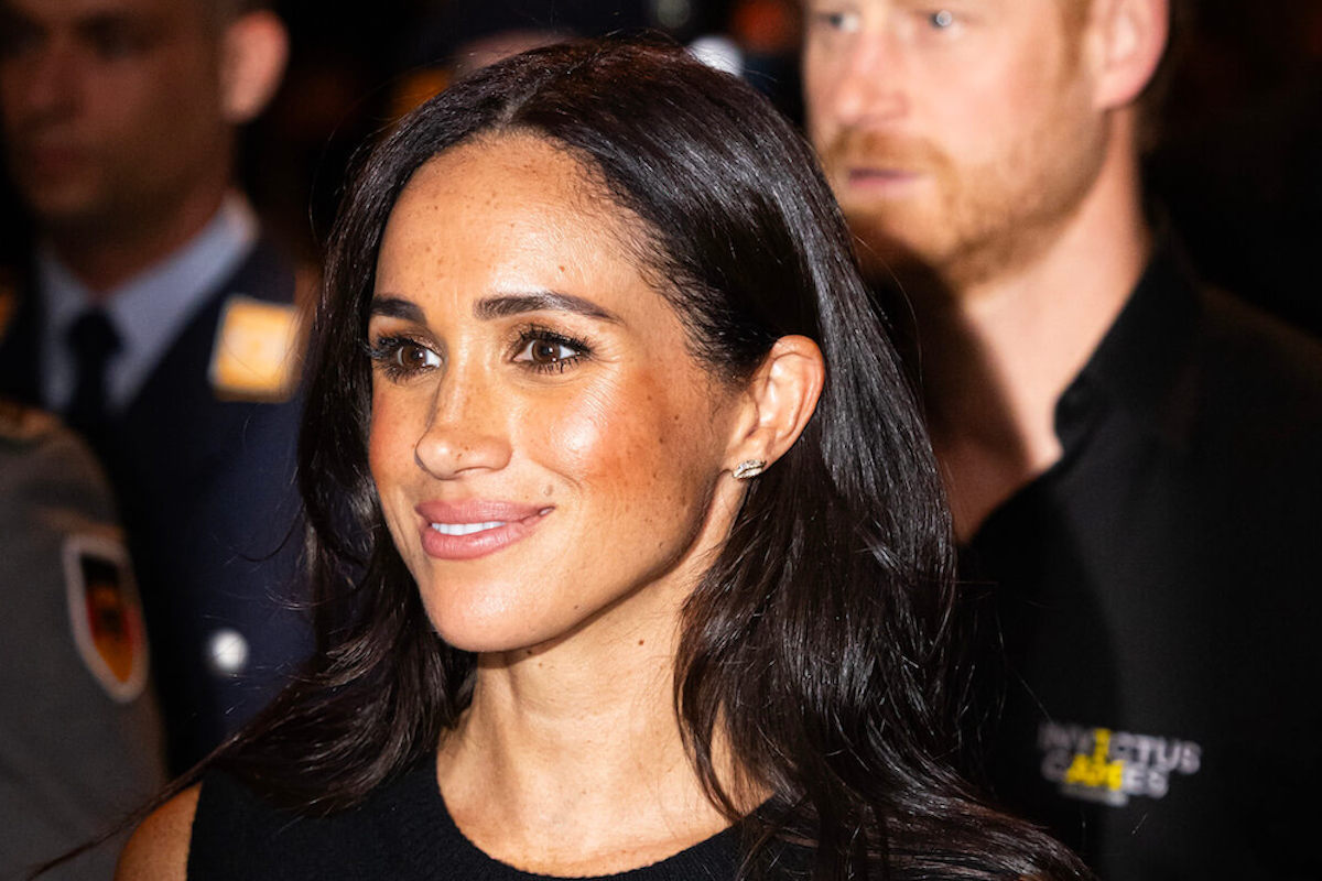 Meghan Markle, whose Invictus Games outfits and wardrobe had a Kate Middleton connection, walks with Prince Harry