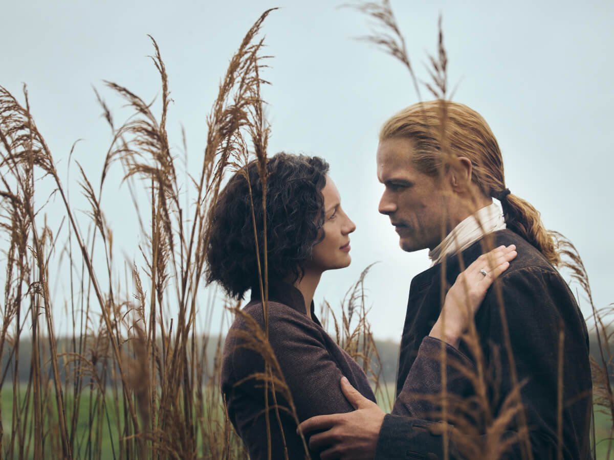 Outlander stars Caitriona Balfe and Sam Heughan pose in an image from season 7