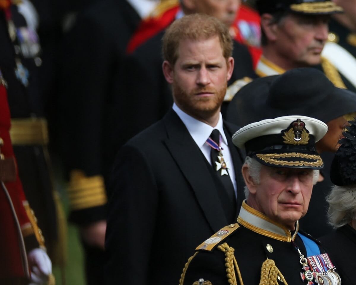 Prince Harry and King Charles III watch as members of the Bearer Party transferring the coffin of Queen Elizabeth II into the State Hearse