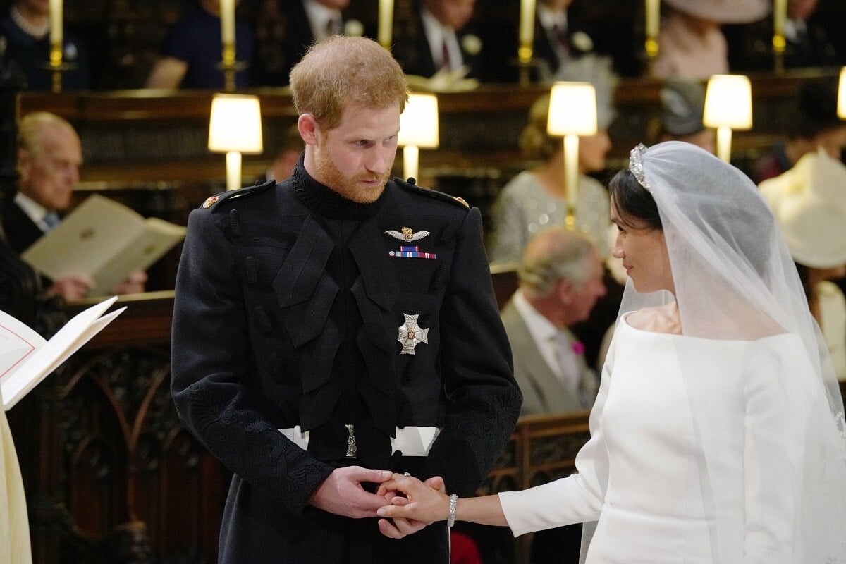 Prince Harry and Meghan Markle stand together hand in hand at the High Altar during their wedding ceremony in St George's Chapel, Windsor Castle