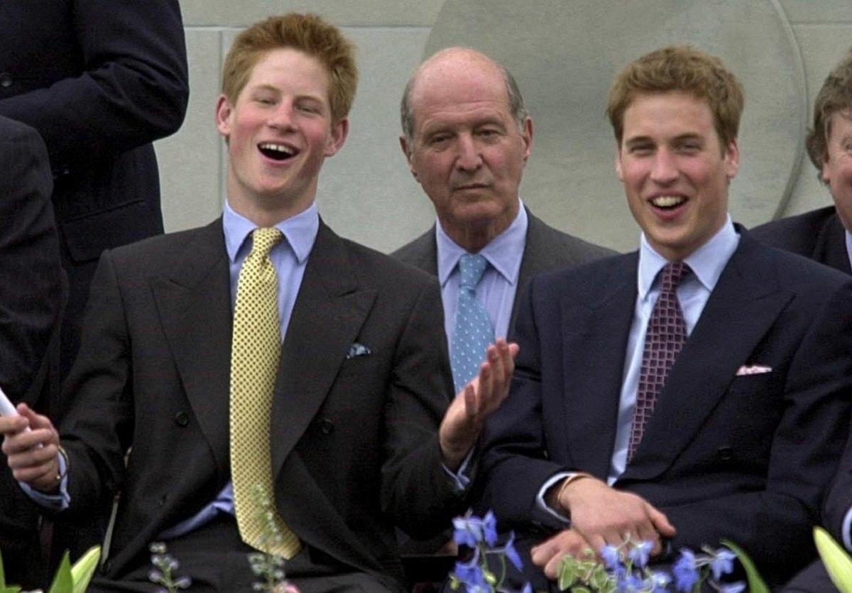 Prince Harry and Prince William when they were teenagers watching a parade on The Mall in London