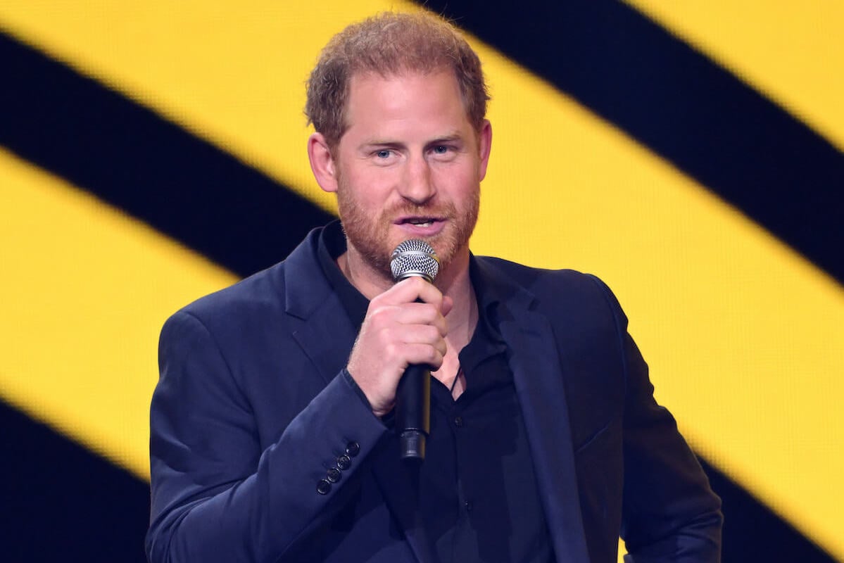 Prince Harry holds a microphone during his closing ceremony speech at the Invictus Games on Sept. 16, 2023.