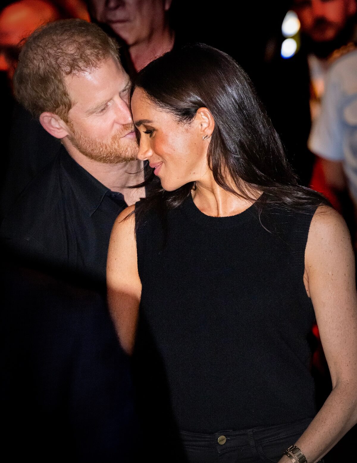 Prince Harry whispering in Meghan Markle's ear at the wheelchair basketball final during Invictus Games