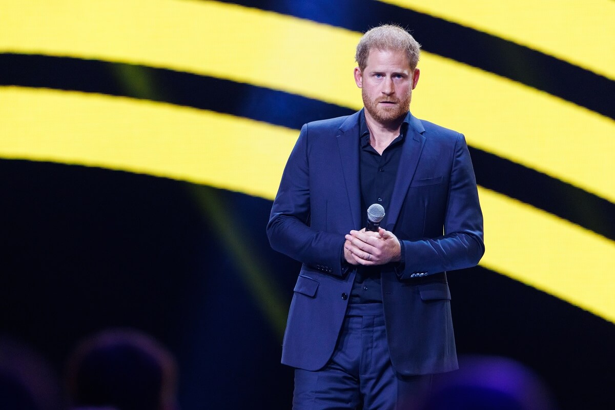 Prince Harry, who a body language expert believes sees his new life without royal status and focus as 'strange,' speaks on stage during the closing ceremony of the Invictus Games Düsseldorf 2023