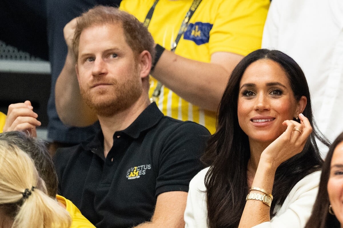 Prince Harry, who a psychic says will re-examine his choices and 'engage in celebrity behavior,' with Meghan Markle at a Wheelchair Basketball match during Invictus Games