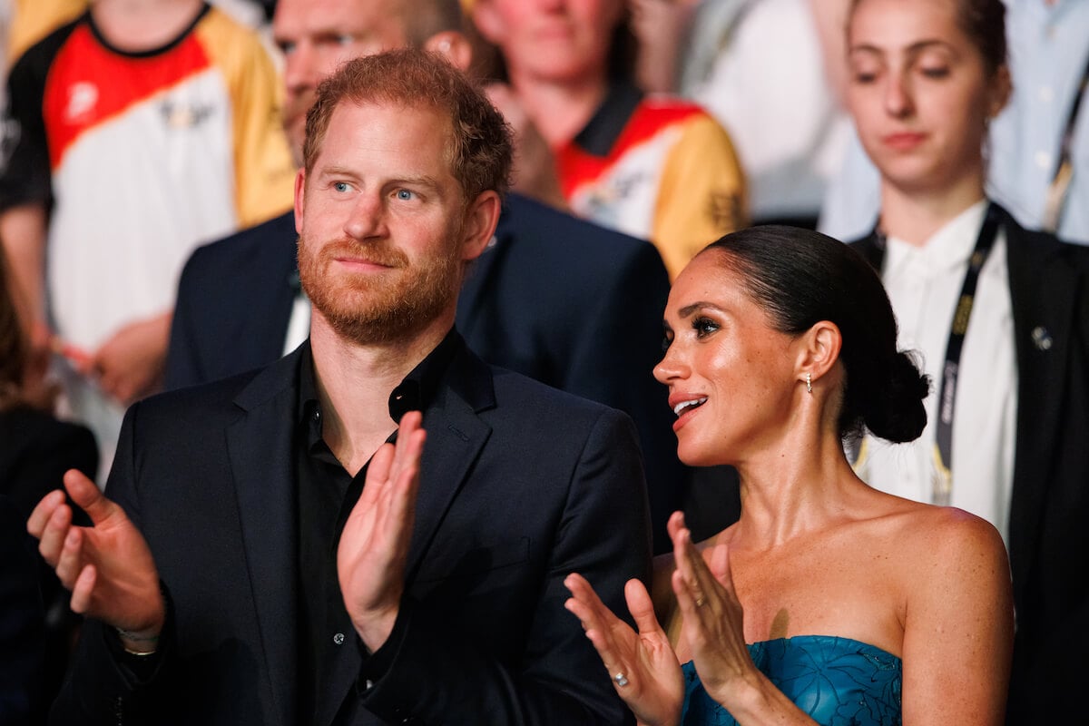 Prince Harry, who looked like a 'trophy husband' with Meghan Markle at a Santa Barbara charity event, stands with Meghan Markle at the 2023 Invictus Games