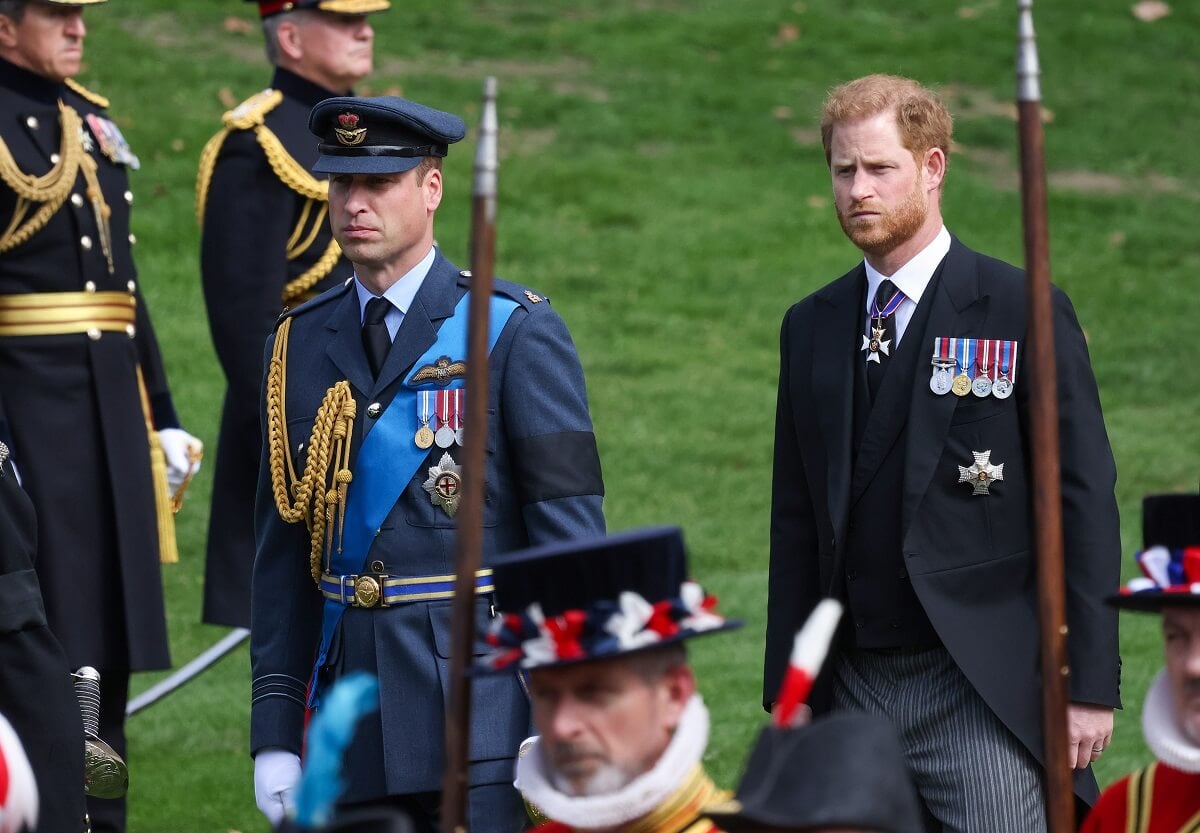 Prince William and Prince Harry watch as the coffin carrying Queen Elizabeth II is transferred to a hearse for its journey to Windsor
