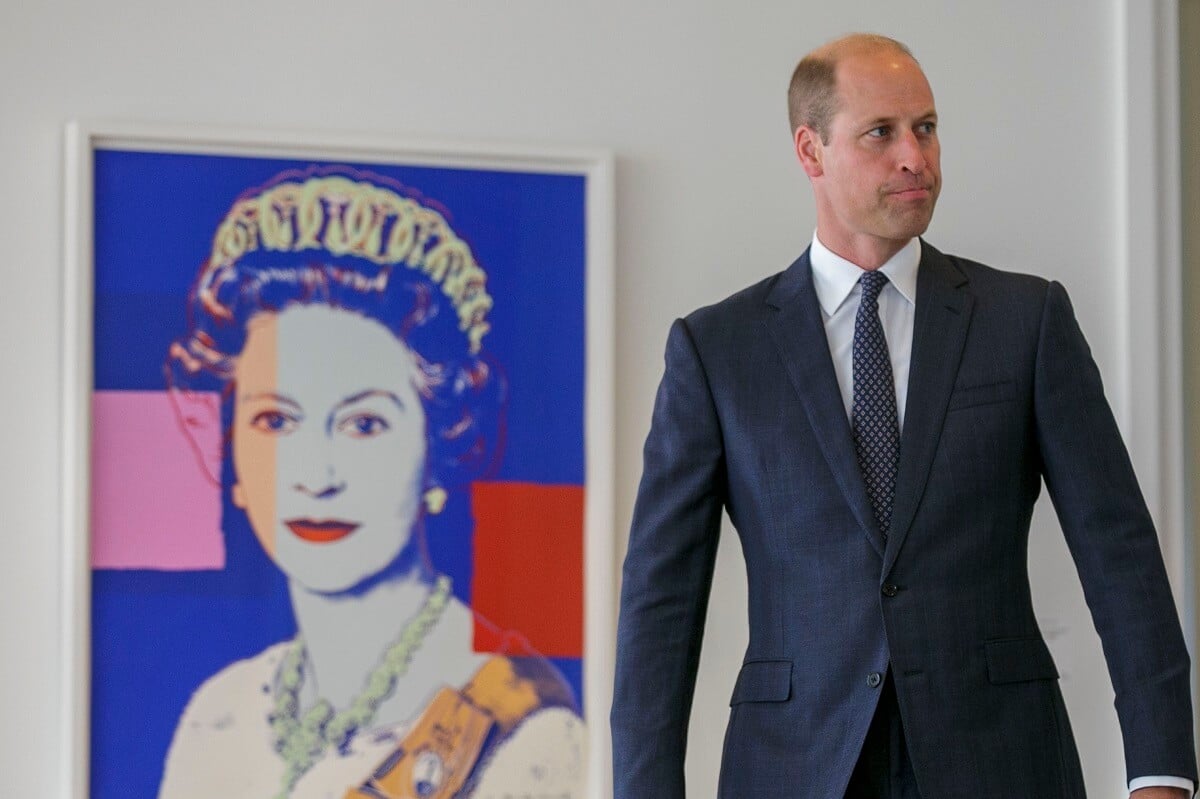 Prince William, who a body language expert says gets 'nervous' sometimes without his confident wife, walks near a print by Andy Warhol of his late grandmother, Queen Elizabeth II, at United Nations
