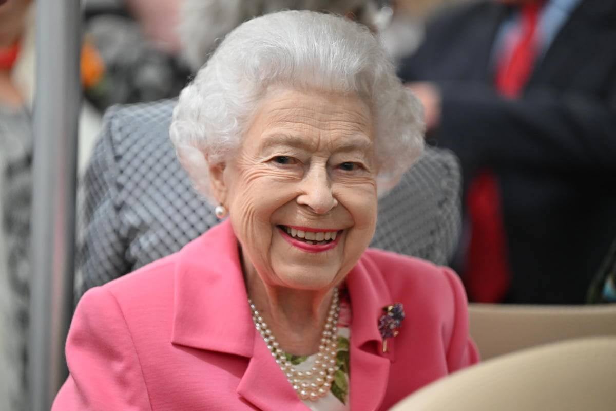 Queen Elizabeth II, who called Prince Archie and Princess Lilibet the 'sweetest children,' according to Prince Harry's 'Spare,' looks on wearing a pink suit.