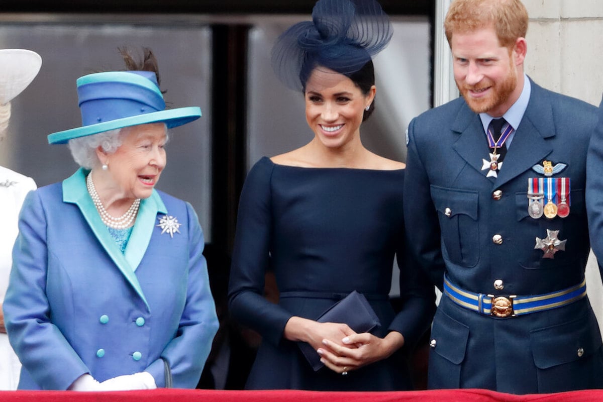 Queen Elizabeth II, who had two words to describe Prince Archie and Princess Lilibet, stands with Meghan Markle and Prince Harry